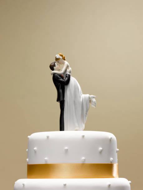 Wedding cake topper with groom lifting bride